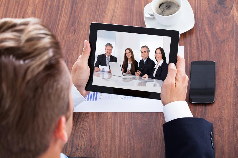 businessman on a video conference holding a tablet