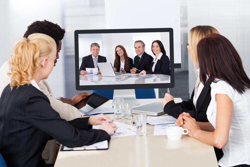VoIP's video conferencing feature helps businesses eliminate some of the common problems associate with in-person meetings. people in a video conference