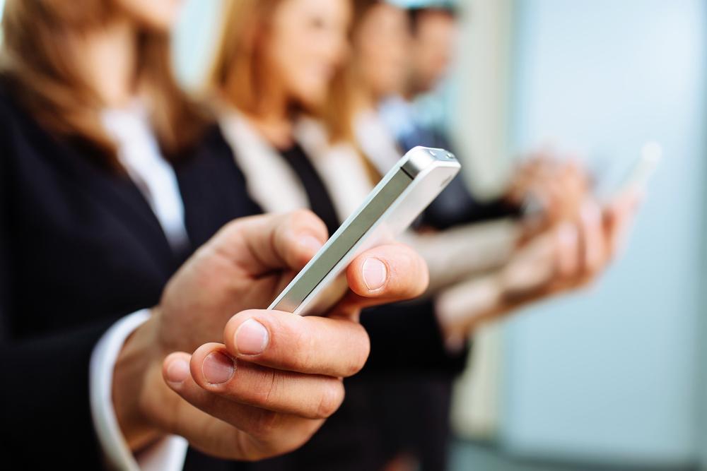 VoIP comes with a great set of features that help mobile employees become productive. employee using smartphone