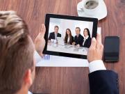 businessman on a video conference holding a tablet